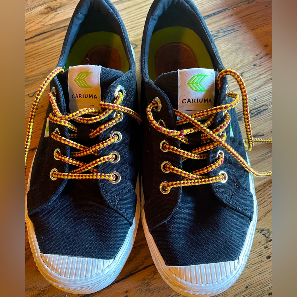 Black canvas sneakers with extra laces and insoles.